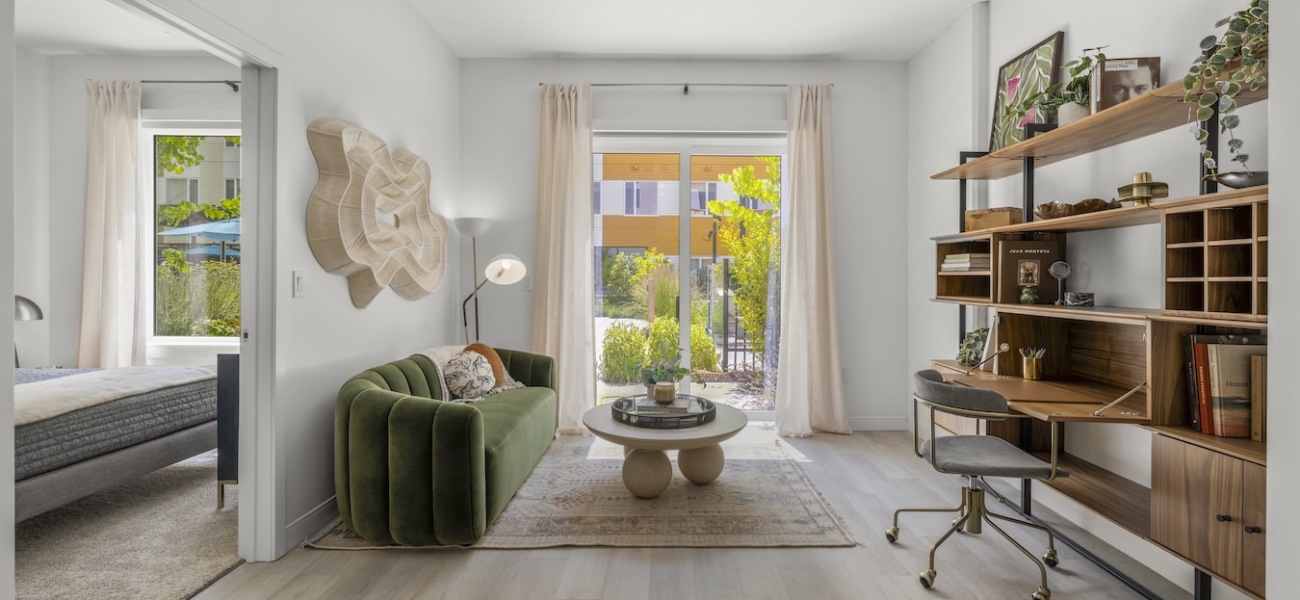Model living room at Maxwell apartments in Everett, MA, featuring wood grain floor paneling